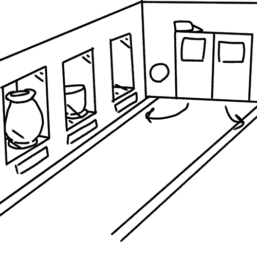 One of the hallways in the ceramics building with more showcase room and automatic doors leading to the studio.